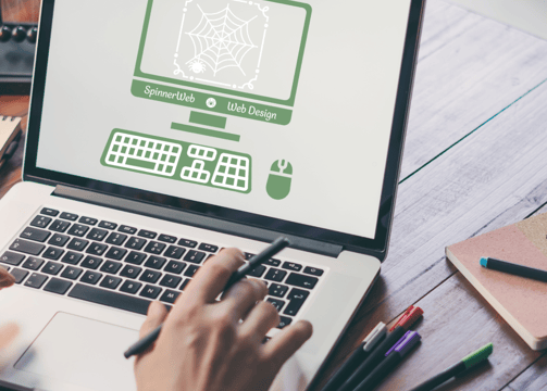 a laptop with a website designers logo on