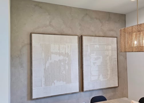 A soft, warm-toned limewash enhances the cozy elegance of this modern dining room in Phoenix.