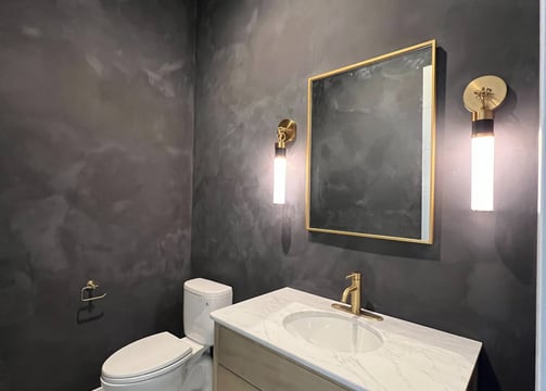  A bold and dramatic black limewash finish enhances the elegance of this luxury bathroom in Phoenix.