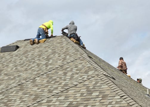 Sooner Construction Roofing Crew at Work put on a new shingled roof.