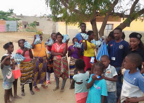 Umoja foundation : a group of people standing around a group of children