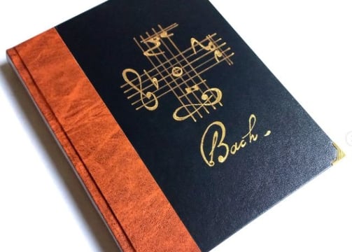 a book with a note pad and a pen