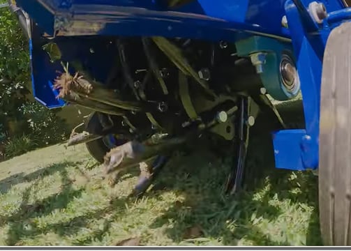 Fertilizer machine moving the dirt to get it ready for new growing process