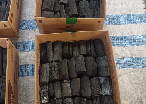 a table with three boxes of charcoal charcoal charcoal charcoal charcoal charcoal charcoal charcoal charcoal charcoal