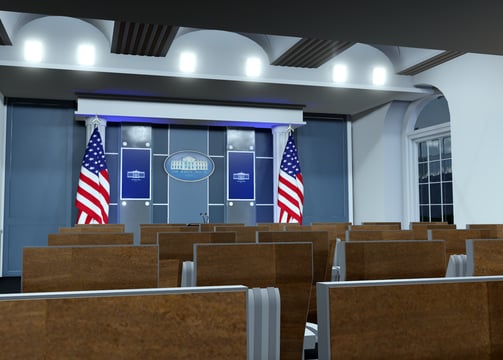 a room with chairs and a podium with flags