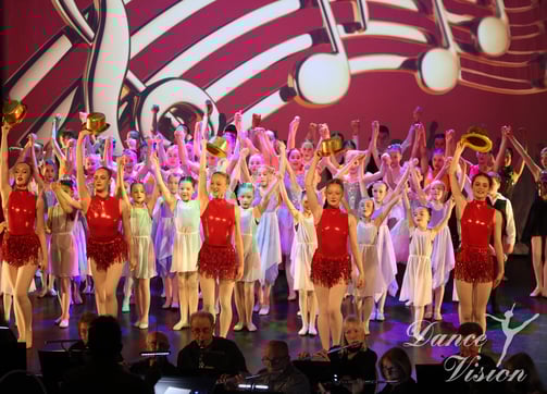 a group of young children and adults performing a musical performance