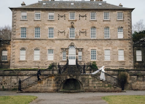 a large stone building with a staircase leading to a stone building