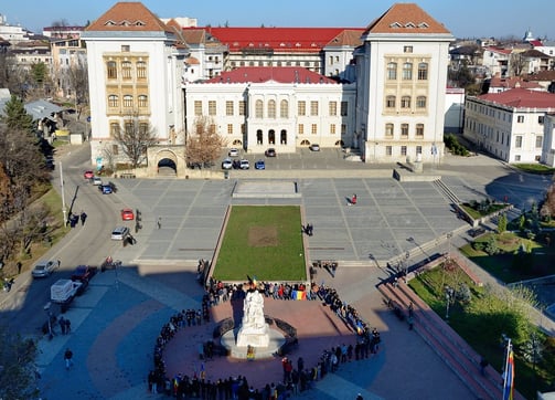 a large group of people standing around a fountain