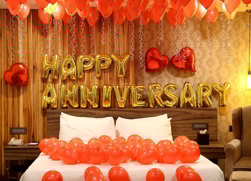 a bed with balloons and balloons on it