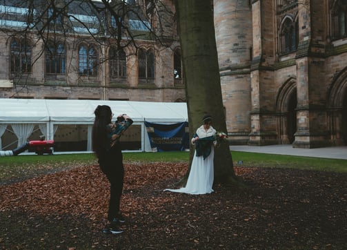 a bride standing in front of a large building