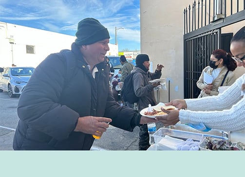 Man thankfully receiving a meal