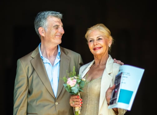 a man and woman standing next to each other on their wedding day