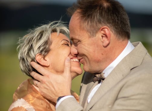 a man and woman kissing in a field