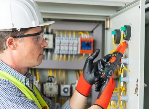 a man in a hard hat and safety glasses