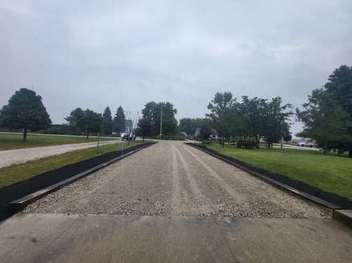 fresh gravel driveway with railroad ties