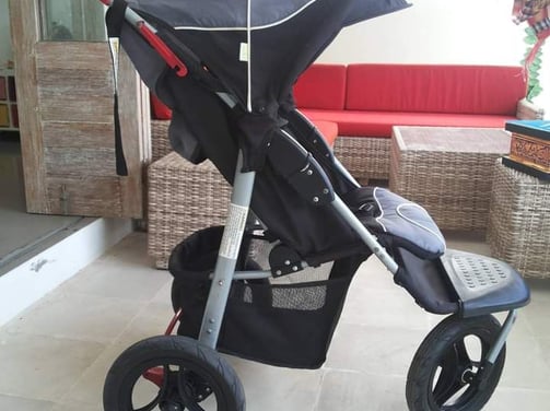 a baby stroller with a baby in a stroller