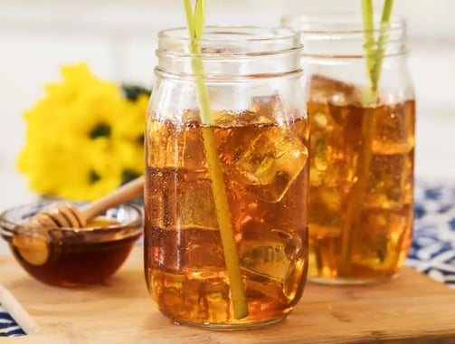 a couple of mason jars filled with iced tea