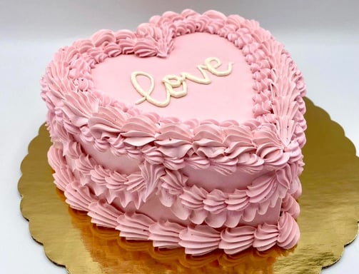 a pink heart shaped cake with a heart shaped cake