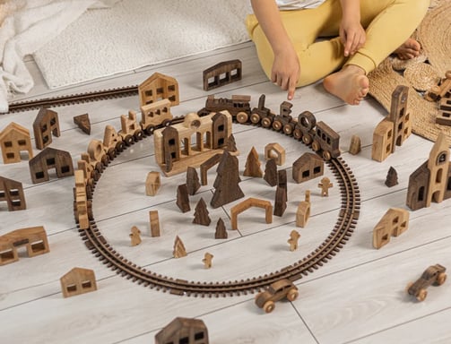 a child's play area with a train set up on the tracks