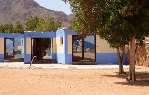 3 Studios blue building with a mountain in the background