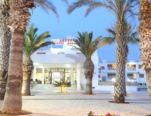 a hotel with palm trees in front in Ayia Napa