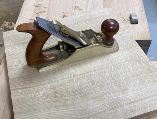 Lie Neilson smoothing plane on solid oak panel
