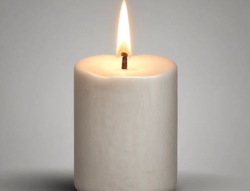 A cluster of white candles is burning amid a bed of flowers, predominantly white chrysanthemums and red roses. The background includes a stone surface with indistinct writing, possibly a memorial or grave marker. The atmosphere is solemn and reverent.