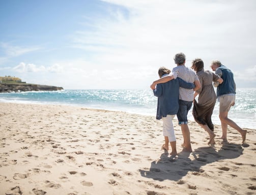 a family of three people walking on a beach