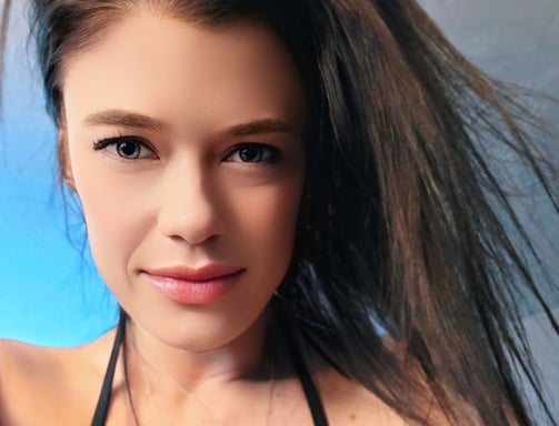 a woman Harley Brooks with long hair and a black bra