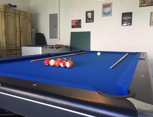 a pool table in a games room in florida villa