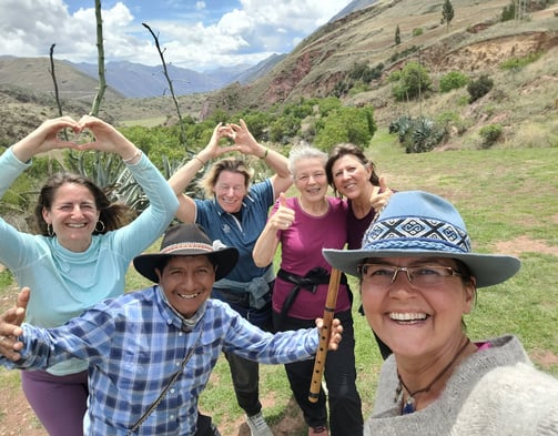 a group of people standing infront of the south gate of Cusco Valley