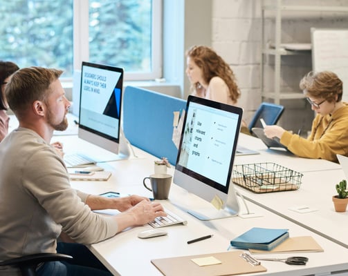 property managers sitting at a table with computers working hard for clients