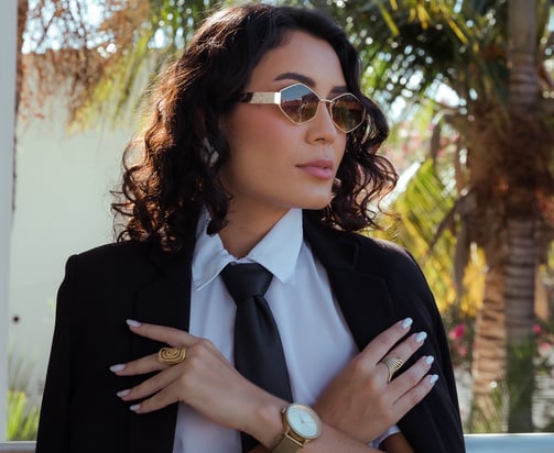 a woman in a suit and tie with a watch