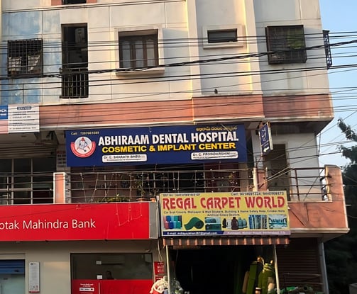 a building with a sign that says abhiraam dental hospitals