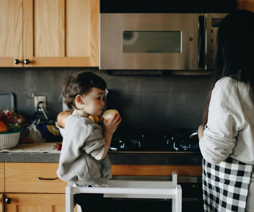 son helping mom in kitchen
