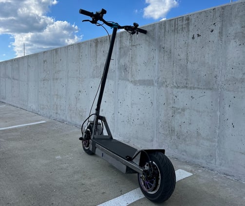 Custom-built electric scooter with 3000W motor, VESC control, and efficient lithium ion battey.