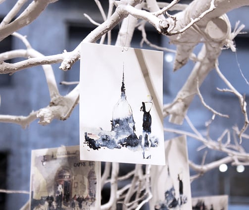 Art installation for My Beautiful Torino event with white tree and watercolor artworks