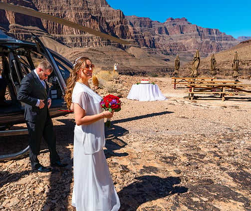 a woman in a white dress and a man in a suit and tie