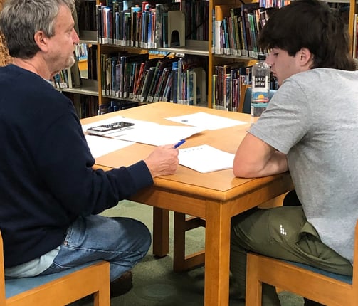 Benny DePoyster conducting an ACT test prep session in a library