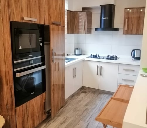 swiss cottages kitchen with a wooden floor and a table with a wooden table and chairs
