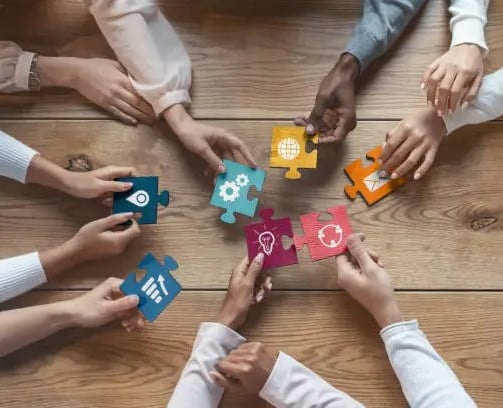 a group of people holding puzzle pieces of puzzle pieces