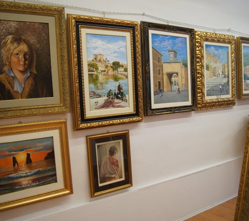 a wall of paintings of paintings of paintings of paintings of people