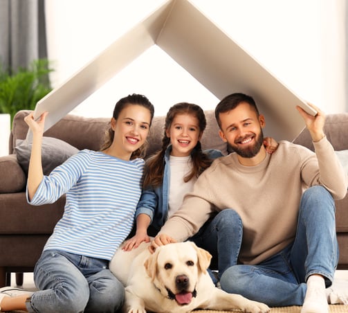a family of four sitting on a couch in a living room