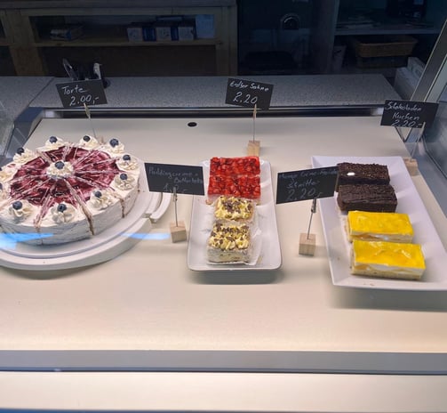 a display case with a variety of desserts
