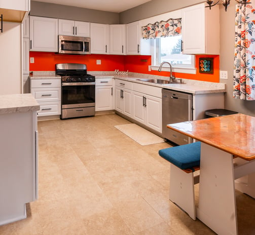 a kitchen with a table and chairs and a table