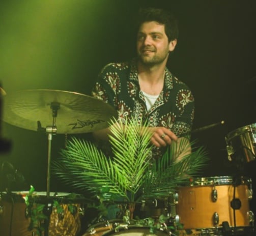 a man playing drums in a band