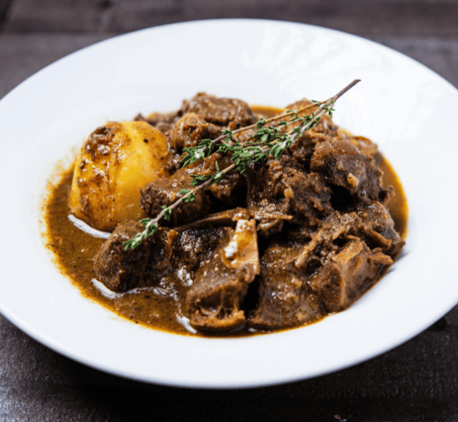 a plate of food with meat and potatoes