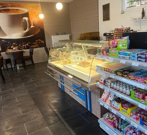a coffee shop with a large cup of coffee and a cup of coffee