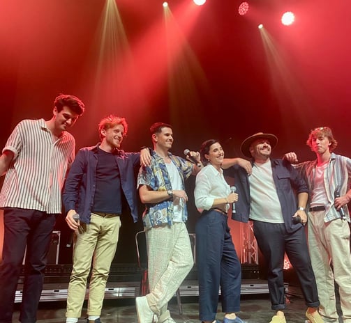 a group of people standing on a stage