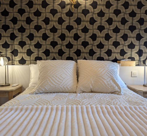 a bed with a white bed and a lamp